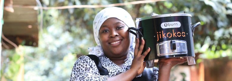Woman holding a portable stove.