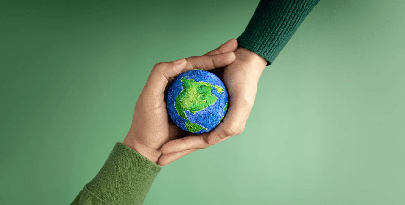 Two hands holding a globe.