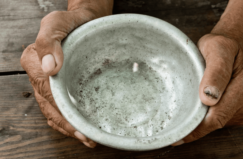 Hands holding a bowl.