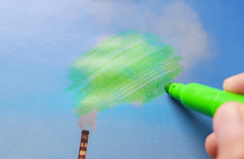 En penna målar grönt över ett moln med avgaser.