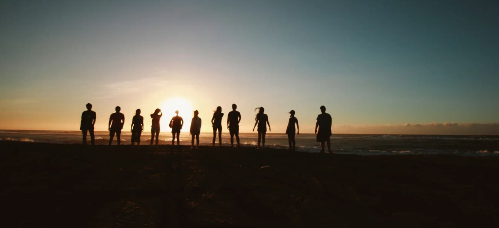 People gathered together at sunset