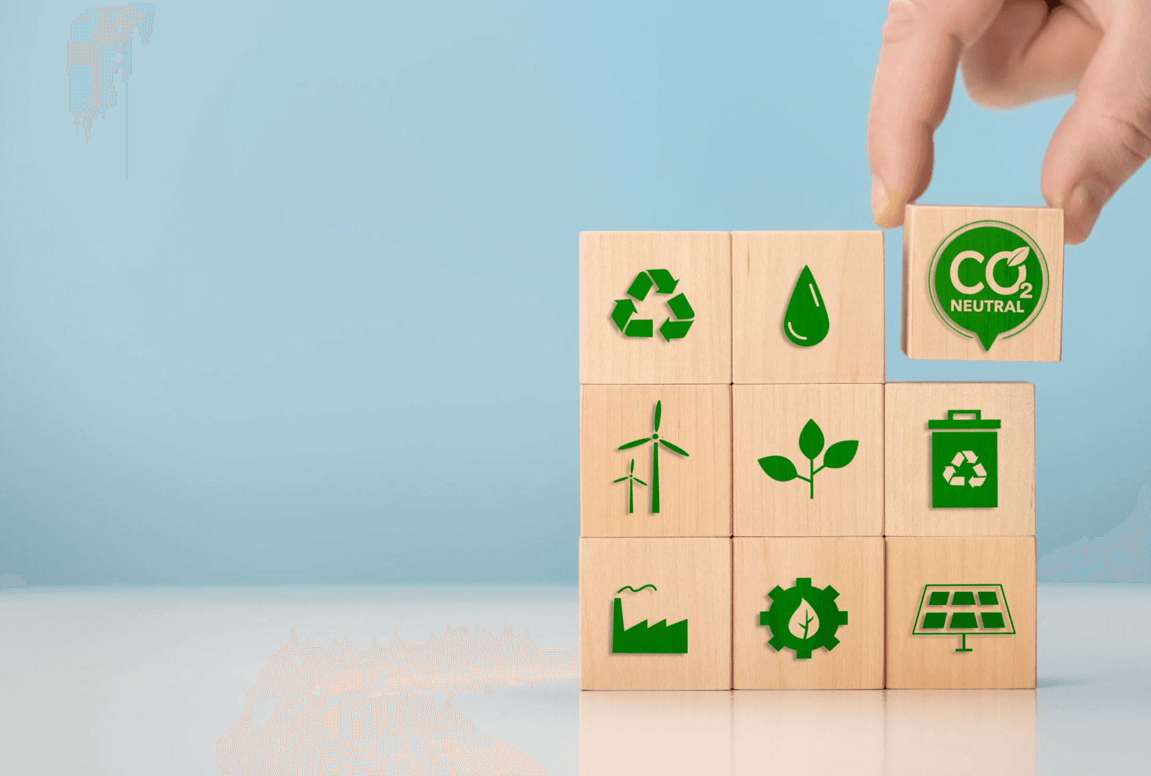 Sustainability symbols on stacked tree cubes.