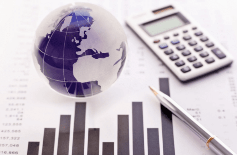 A globe, graphs, a calculator and a pen.