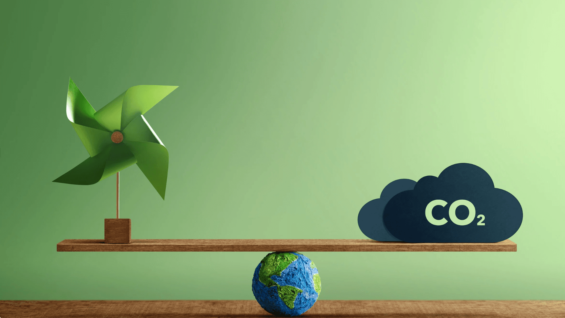 A globe balances a wooden plank.