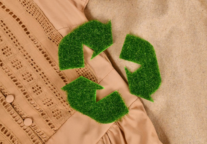 A recycling symbol on top of fabric.