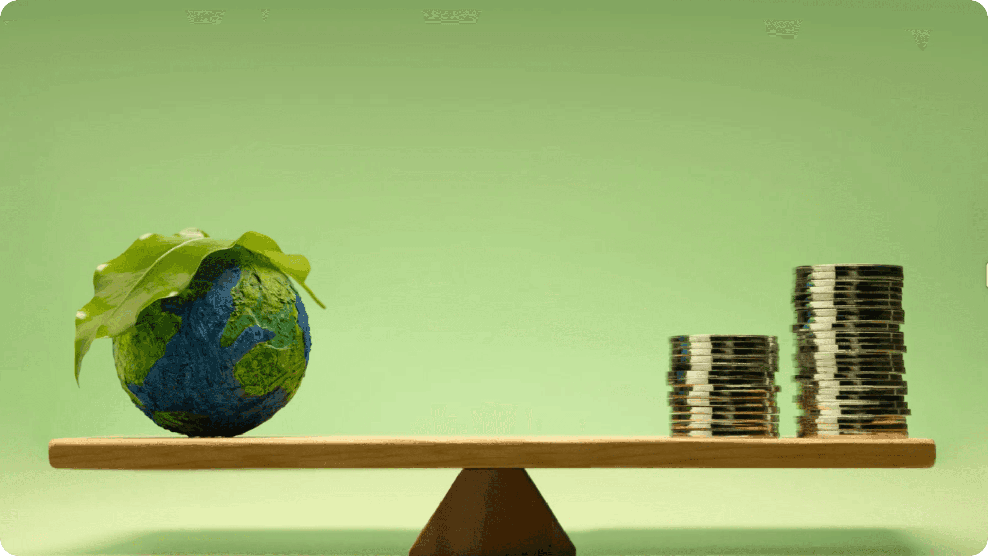 A globe and stacks of coins balancing.