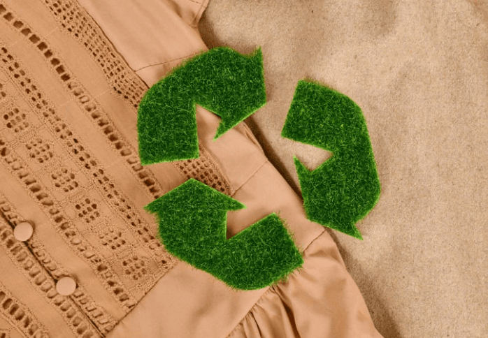 A recycling symbol on top of fabric.